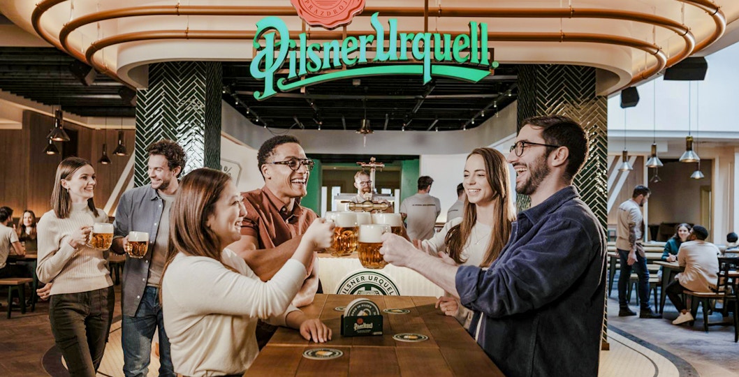 Tourists enjoying beer tasting at Pilsner Urquell The Original Beer Experience in Prague.