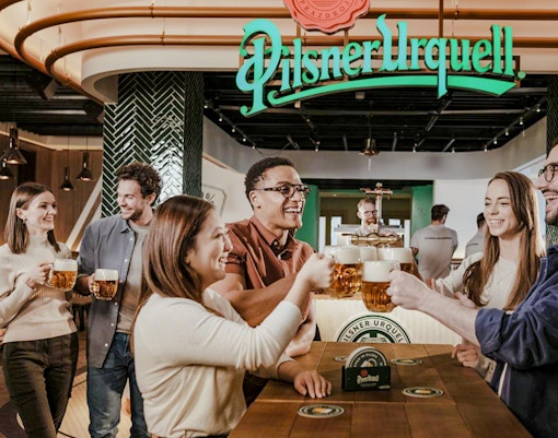 Tourists enjoying beer tasting at Pilsner Urquell The Original Beer Experience in Prague.