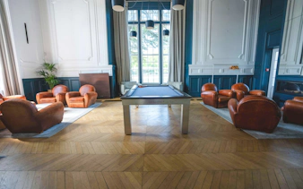 Pool table and leather chairs in a lounge at Clairefontaine, French National Football Center, Paris.