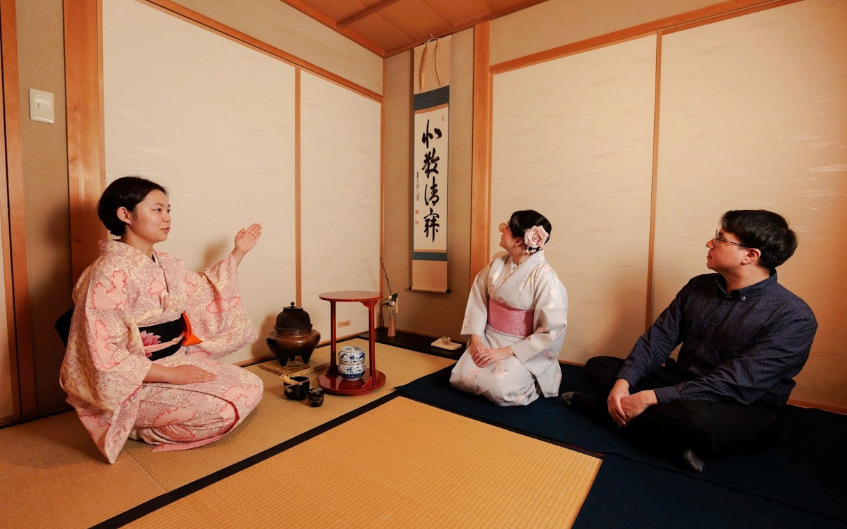 Participants in traditional attire during a Japanese tea ceremony.
