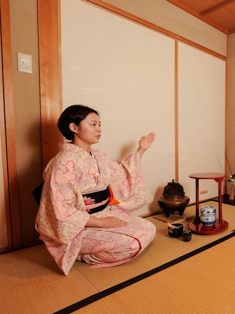 Participants in traditional attire during a Japanese tea ceremony.