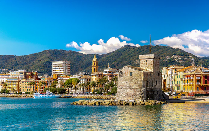 Rapallo seaside with historic castle and colorful buildings, day trip from Genoa to Portofino.