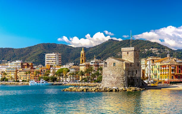 Rapallo seaside with historic castle and colorful buildings, day trip from Genoa to Portofino.