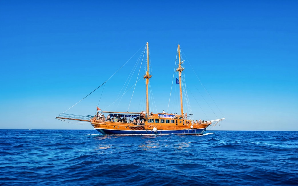 Turkish gulet sailing from Sliema to Gozo and Comino with passengers on deck.