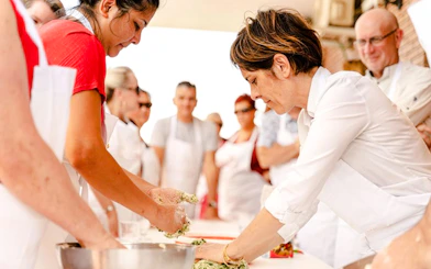 Participants kneading dough during a Genoese cooking lesson in Genoa.