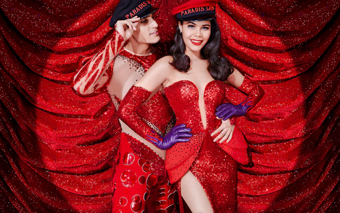 Characters in festive costumes at Paradis Latin cabaret.