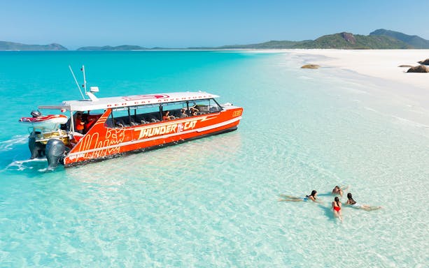 Thundercat catamaran sailing through turquoise waters of Whitsundays, Australia.