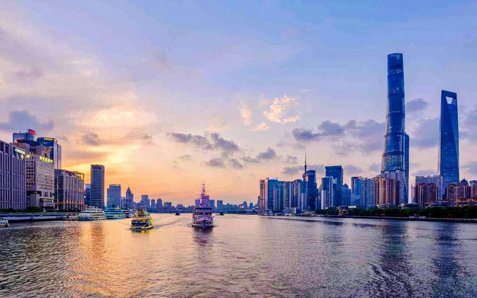 Shanghai skyline with Shanghai Tower and Oriental Pearl Tower at sunset.