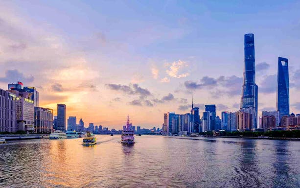 Shanghai skyline with Shanghai Tower and Oriental Pearl Tower at sunset.