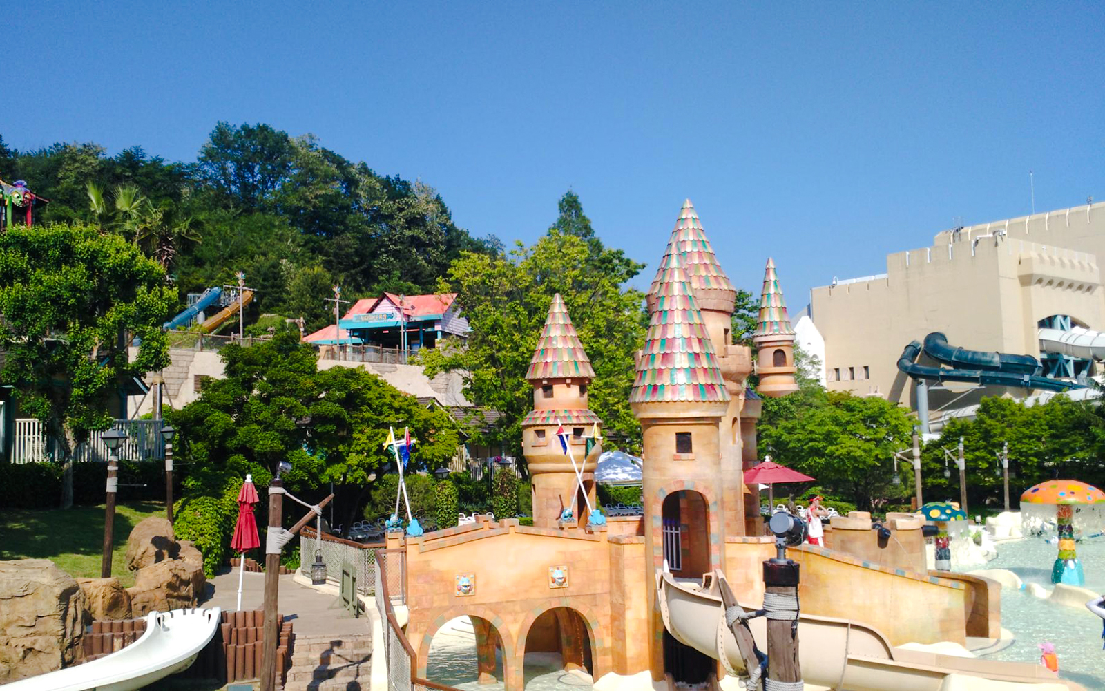 Castle-themed water ride at Caribbean Bay Water Park with slides and colorful towers.