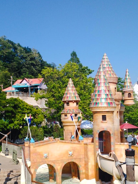 Castle-themed water ride at Caribbean Bay Water Park with slides and colorful towers.