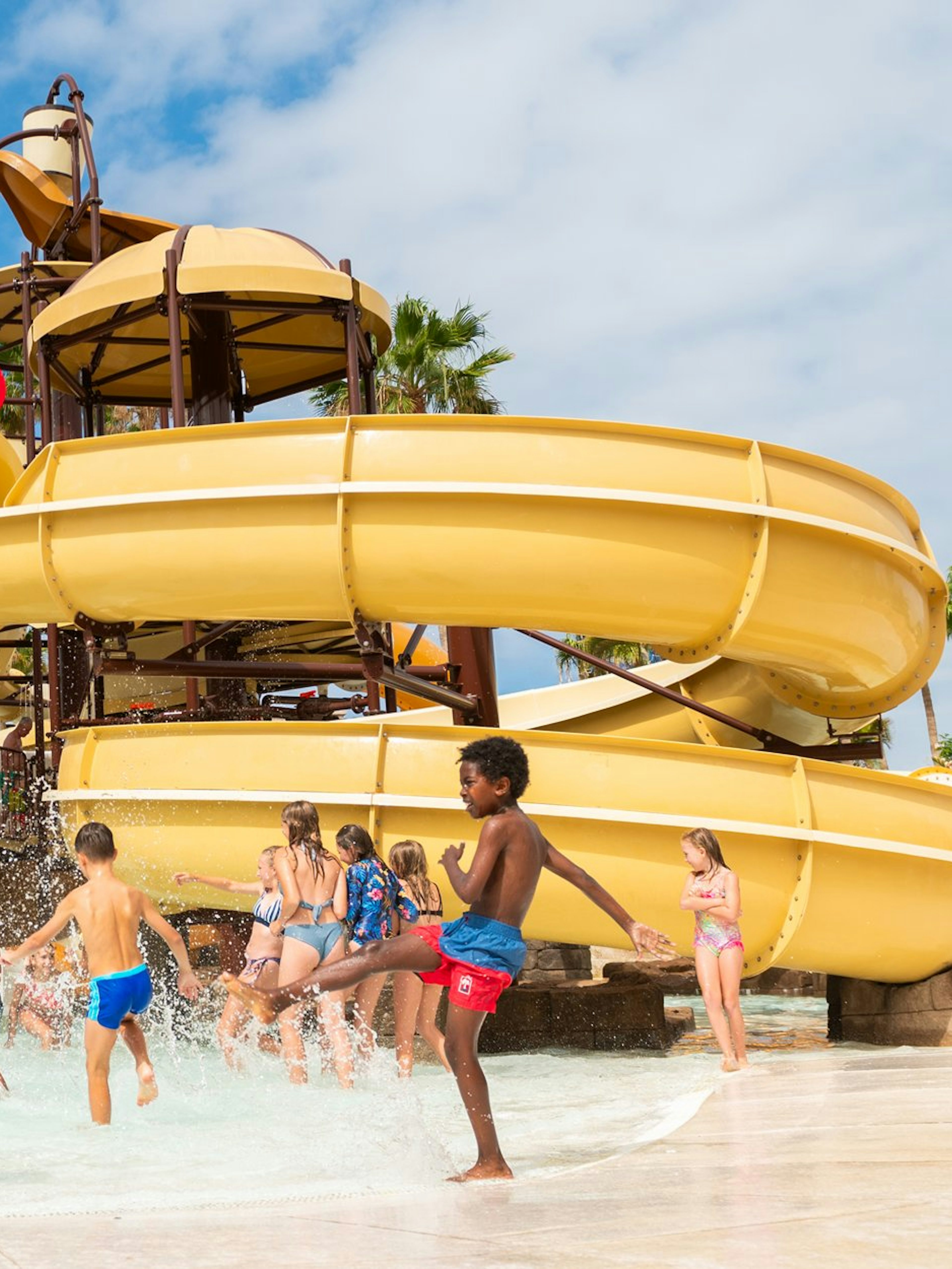 Children playing in water near slides at Aqualand Costa Adeje.