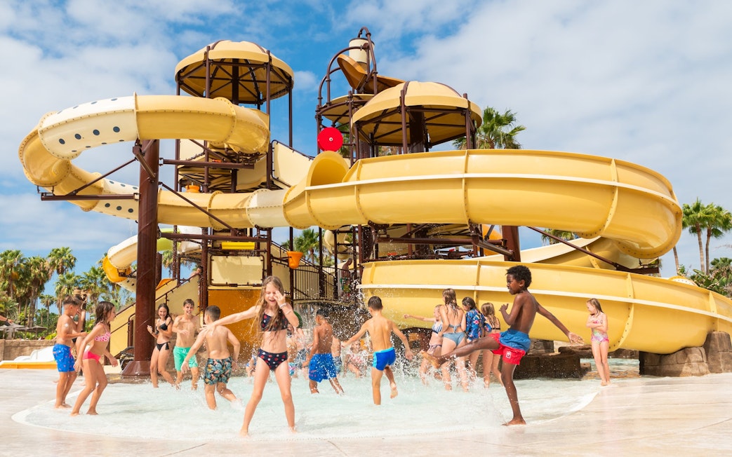 Children playing in water near slides at Aqualand Costa Adeje.