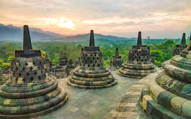 Stupas at Borobudur Temple with sunrise in Yogyakarta, Indonesia.