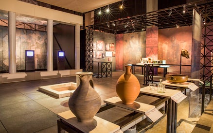 Museum exhibit with ancient pottery and artifacts at Pont du Gard, France.