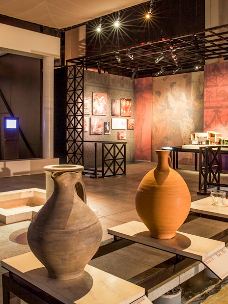 Museum exhibit with ancient pottery and artifacts at Pont du Gard, France.
