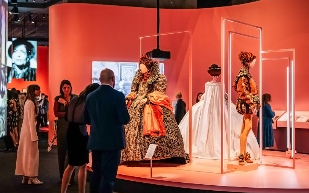 Visitors viewing historical costumes at Art Science Museum's Future World exhibit.