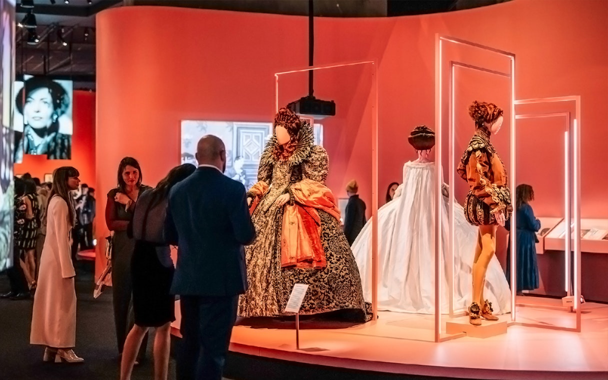 Visitors viewing historical costumes at Art Science Museum's Future World exhibit.