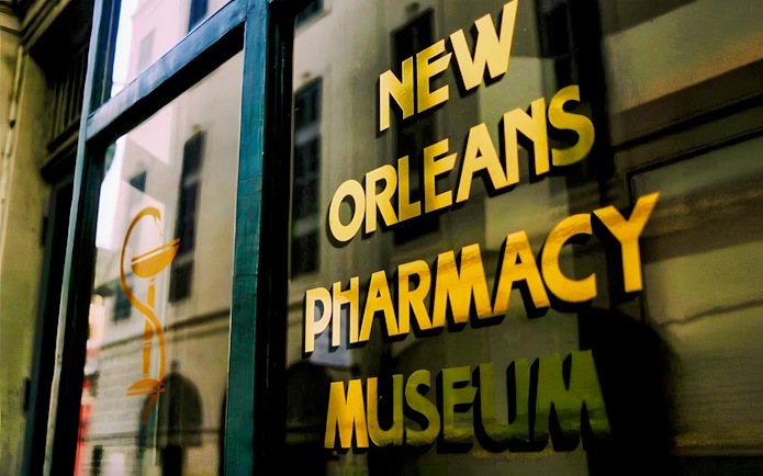 New Orleans Pharmacy Museum sign reflecting historic building.