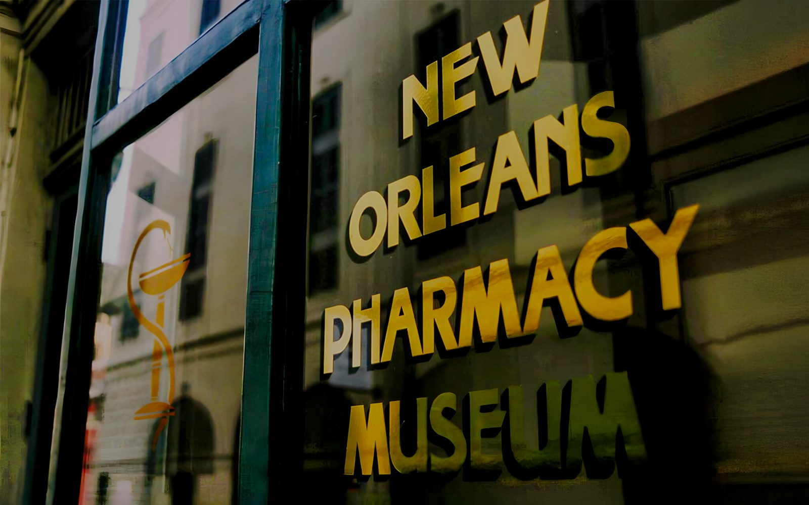 New Orleans Pharmacy Museum sign reflecting historic building.