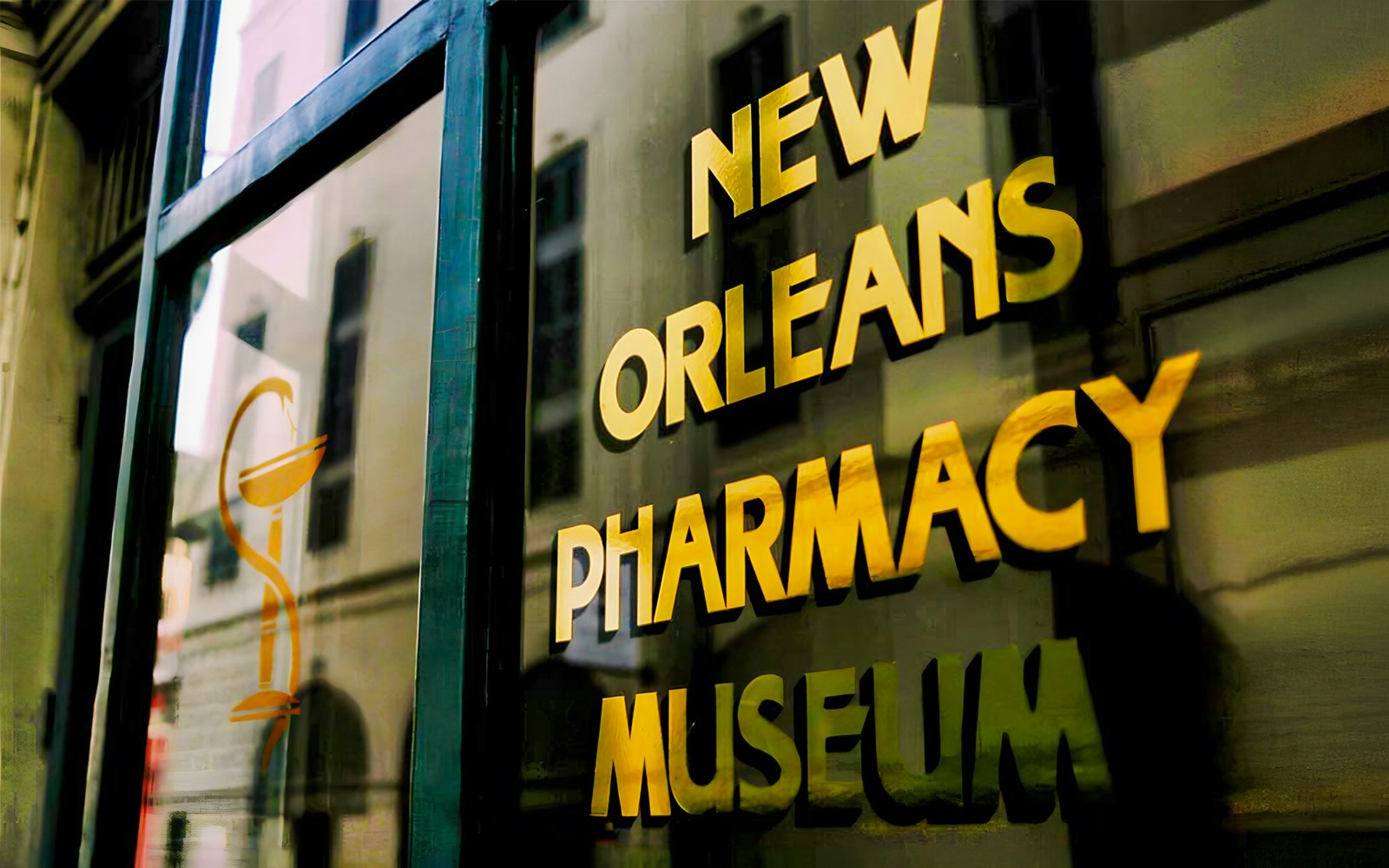 New Orleans Pharmacy Museum sign reflecting historic building.