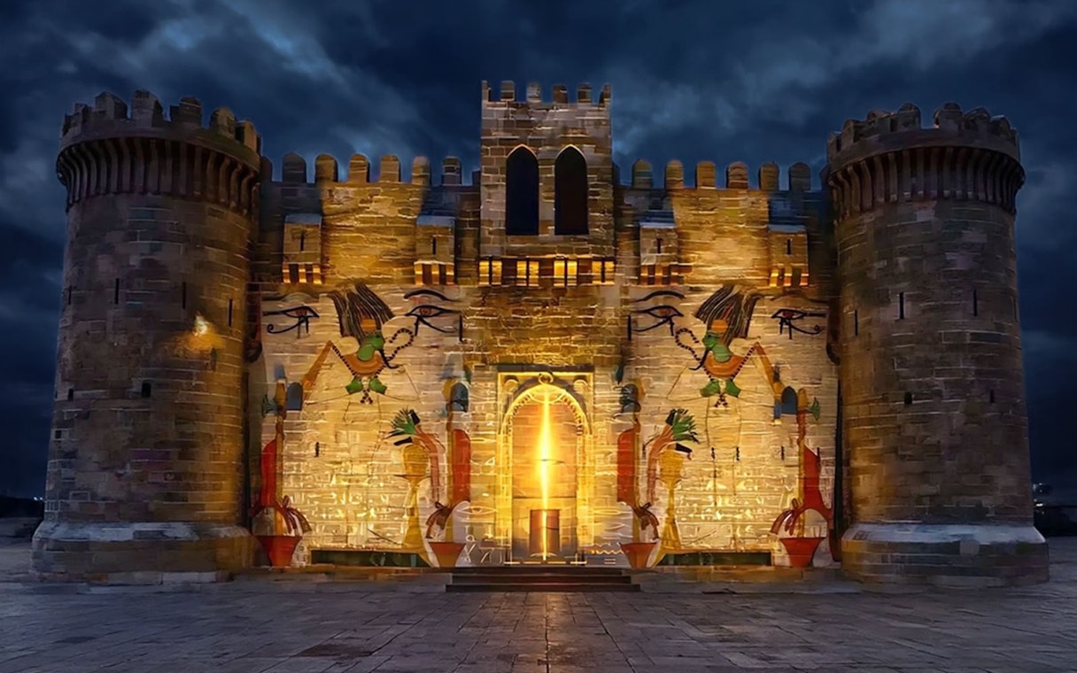Qaitbay Citadel illuminated at night with ancient Egyptian motifs, Alexandria, Egypt.