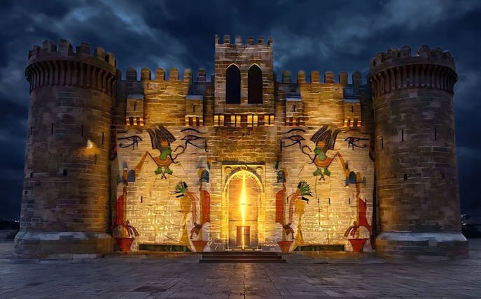 Qaitbay Citadel illuminated at night with ancient Egyptian motifs, Alexandria, Egypt.
