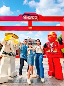 Family posing with Ninjago Lego figures at LEGOLAND Malaysia Theme Park.