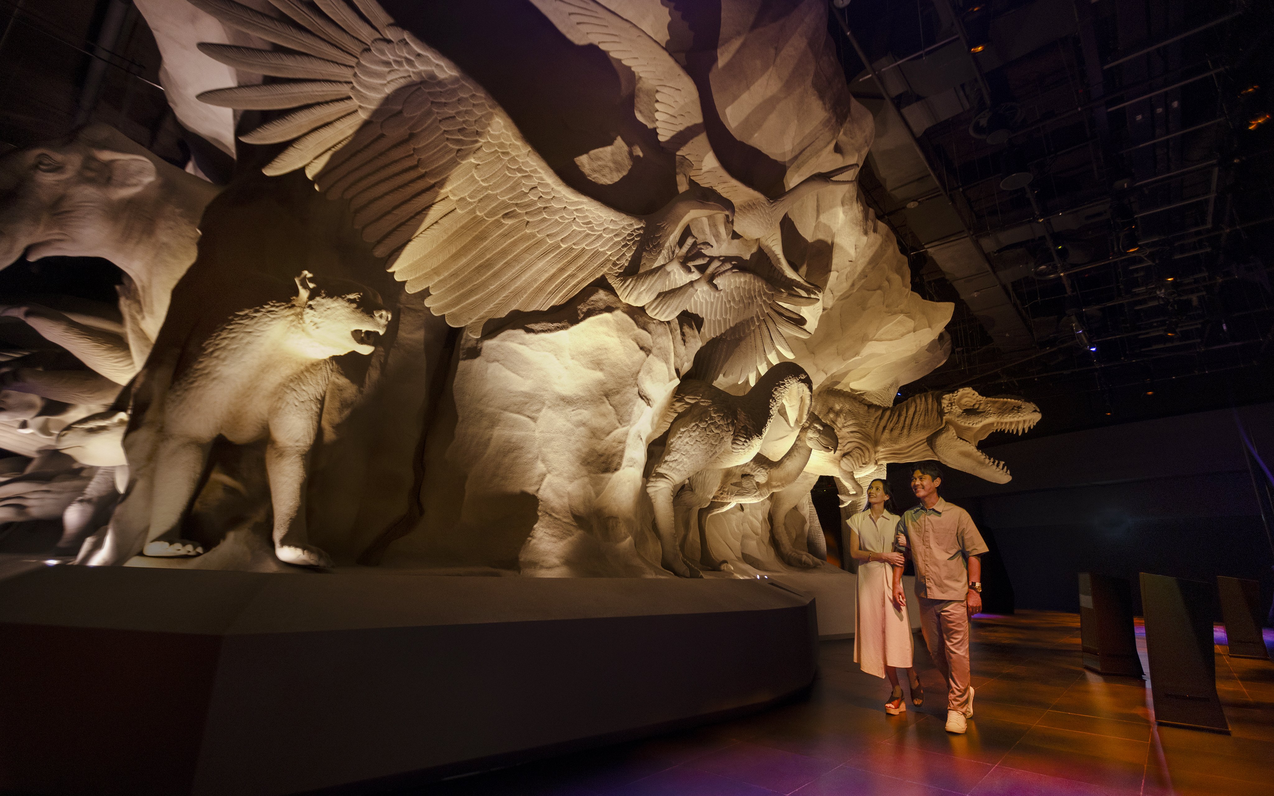 Visitors exploring Realm of Giants exhibit at Exploria, Mandai Wildlife, featuring large animal sculptures.