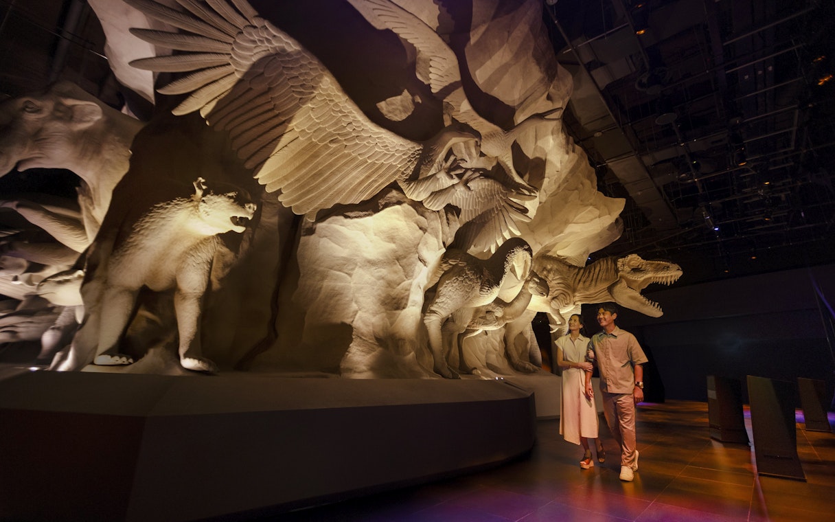 Visitors exploring Realm of Giants exhibit at Exploria, Mandai Wildlife, featuring large animal sculptures.