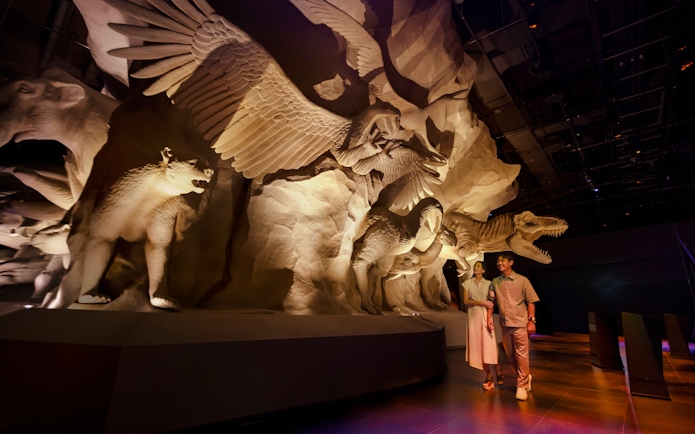 Visitors exploring Realm of Giants exhibit at Exploria, Mandai Wildlife, featuring large animal sculptures.