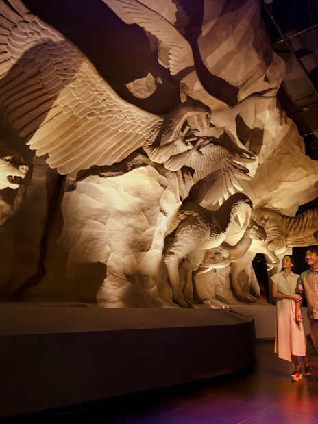 Visitors exploring Realm of Giants exhibit at Exploria, Mandai Wildlife, featuring large animal sculptures.