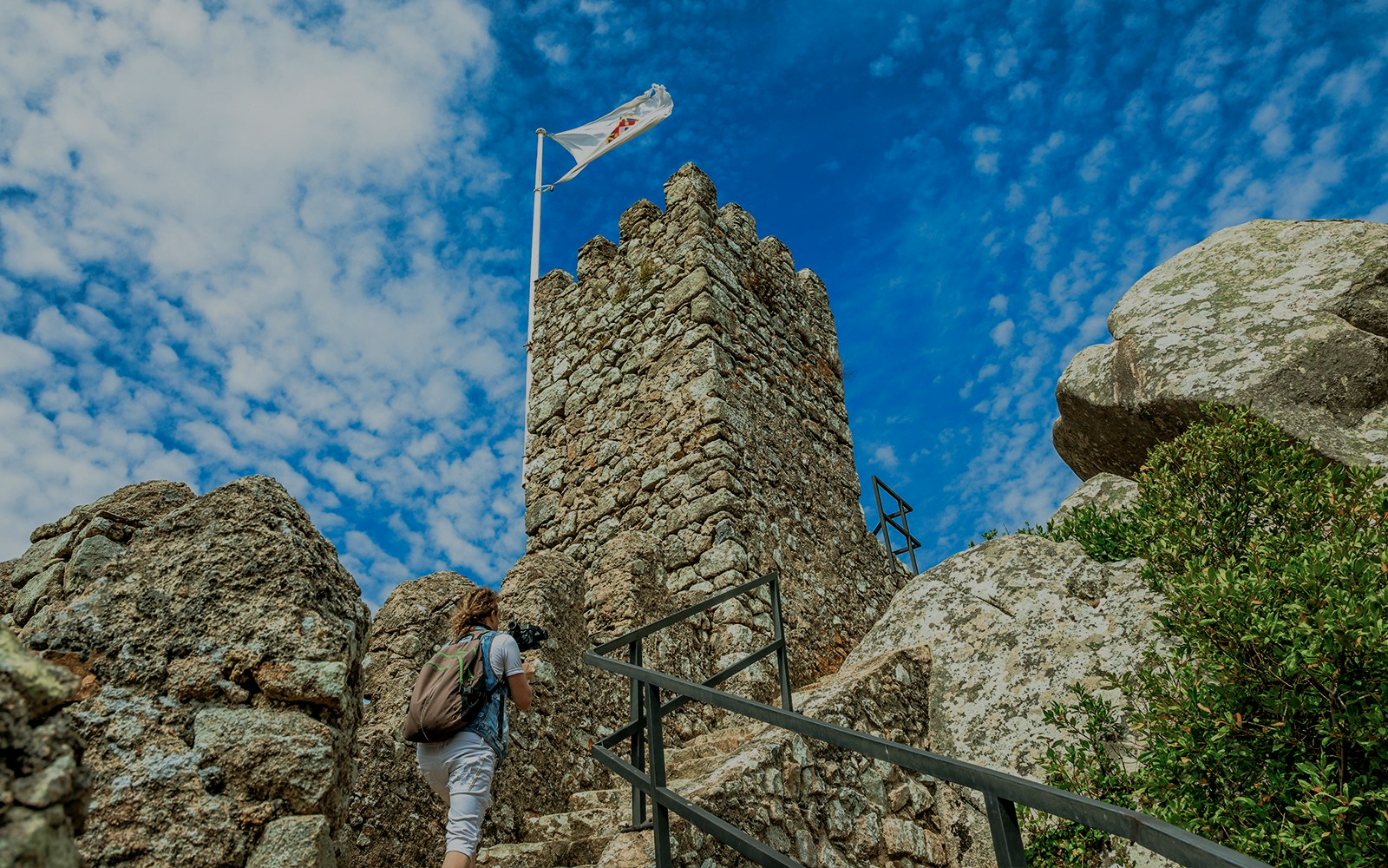Visitor climbing steps at Moorish Castle, Sintra, Portugal.