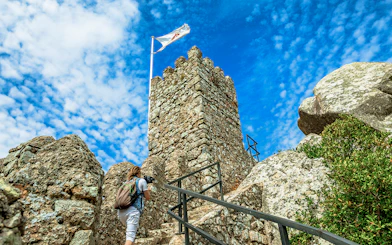 Visitor climbing steps at Moorish Castle, Sintra, Portugal.