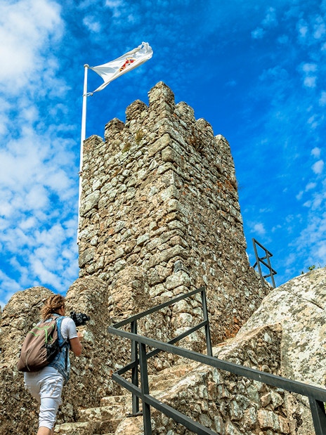 Visitor climbing steps at Moorish Castle, Sintra, Portugal.
