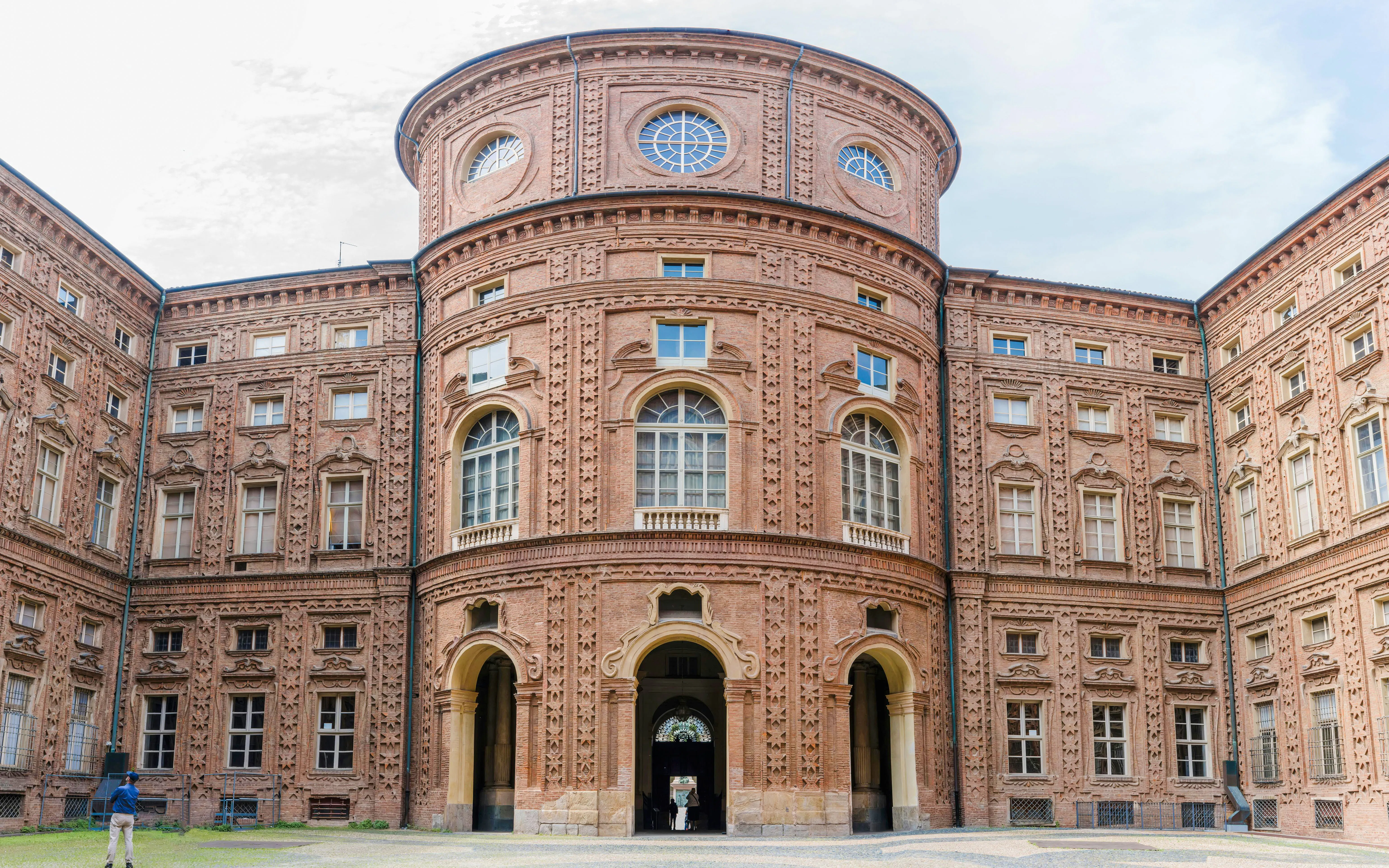 Facade of Museo Egizio in Turin, Italy, showcasing ornate brick architecture.