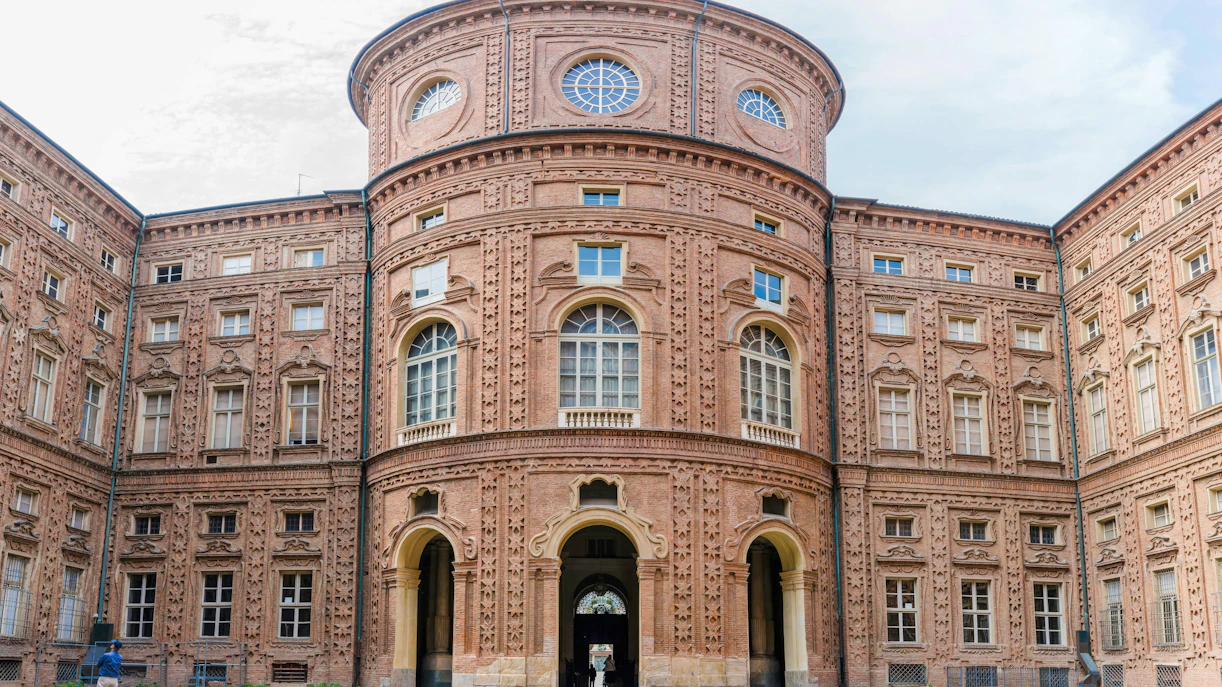 Facade of Museo Egizio in Turin, Italy, showcasing ornate brick architecture.