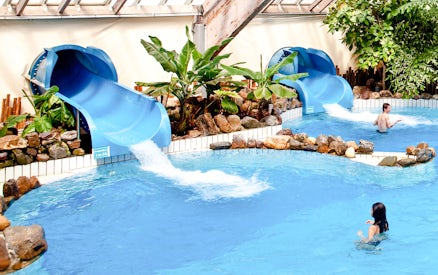 Water slides and pool at Aquaboulevard de Paris indoor water park.