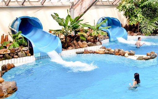 Water slides and pool at Aquaboulevard de Paris indoor water park.