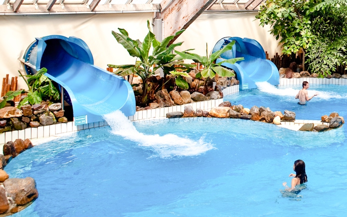 Water slides and pool at Aquaboulevard de Paris indoor water park.