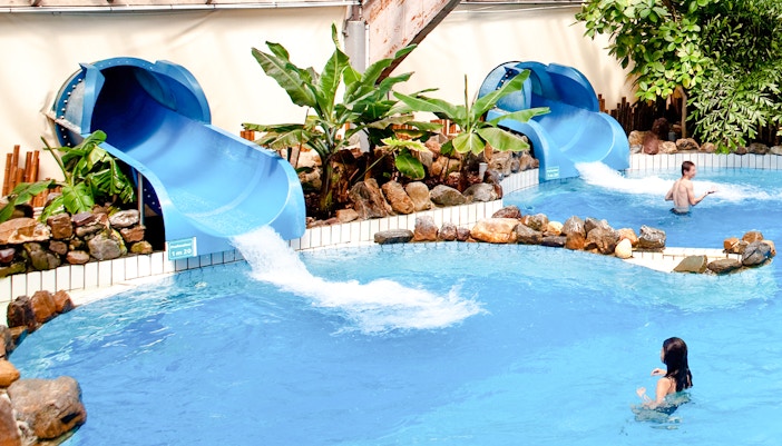 Water slides and pool at Aquaboulevard de Paris indoor water park.