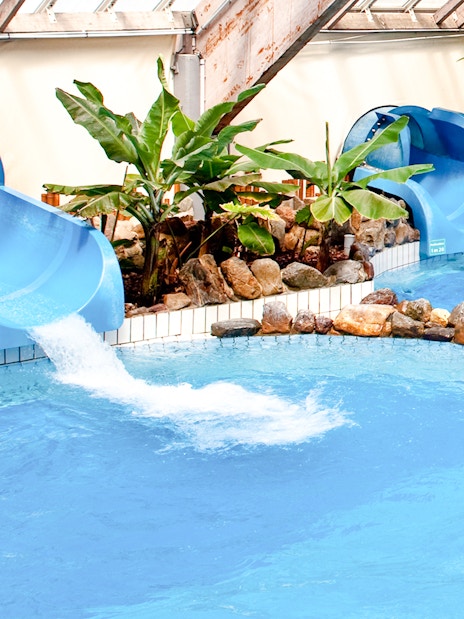 Water slides and pool at Aquaboulevard de Paris indoor water park.
