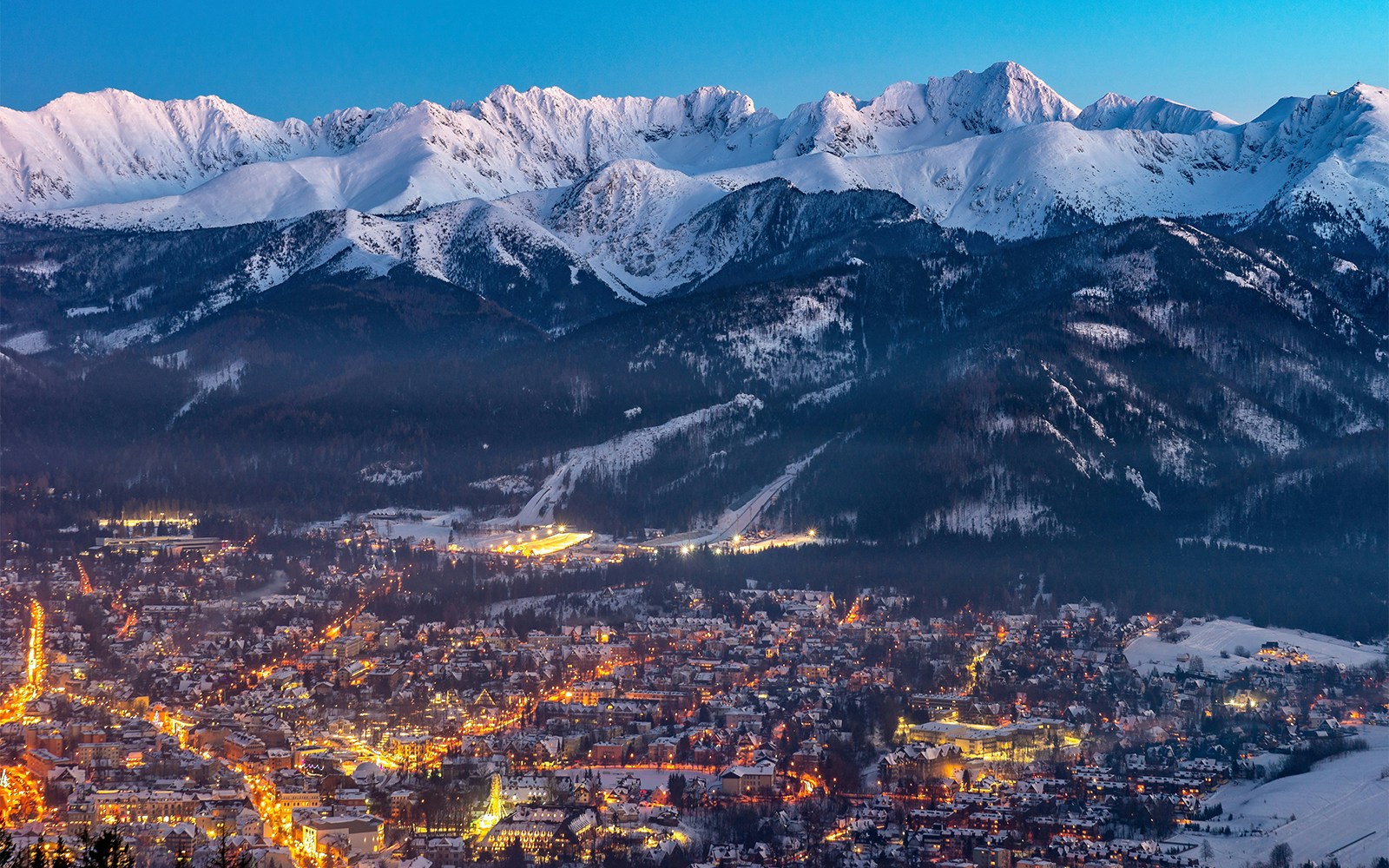 Zakopane cityscape with Tatra Mountains at dusk, Poland.