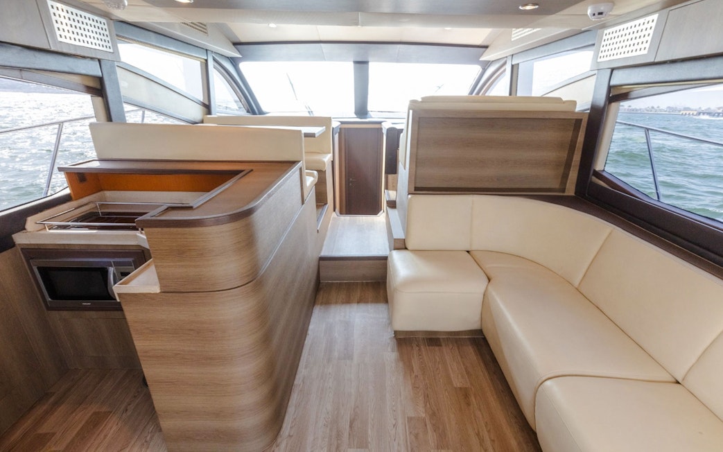 Interior of Viktoriia Luxury Yacht with seating and kitchenette.
