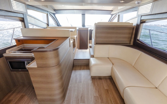 Interior of Viktoriia Luxury Yacht with seating and kitchenette.