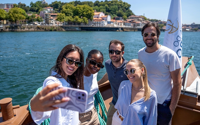 Group enjoying Douro River cruise in Porto, Portugal.