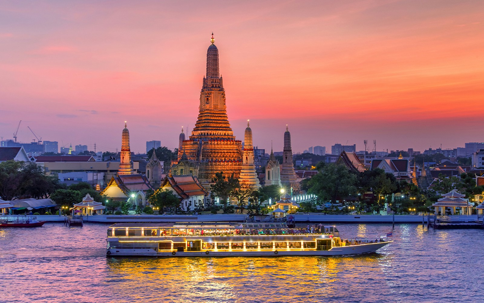 Chao Phraya Princess Cruise passing Wat Arun at sunset in Bangkok.