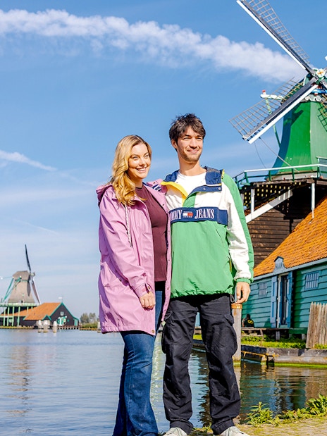 Guests posing at Zaanse Schans windmills, photographed by a guide.