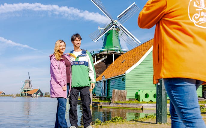 Guests posing at Zaanse Schans windmills, photographed by a guide.