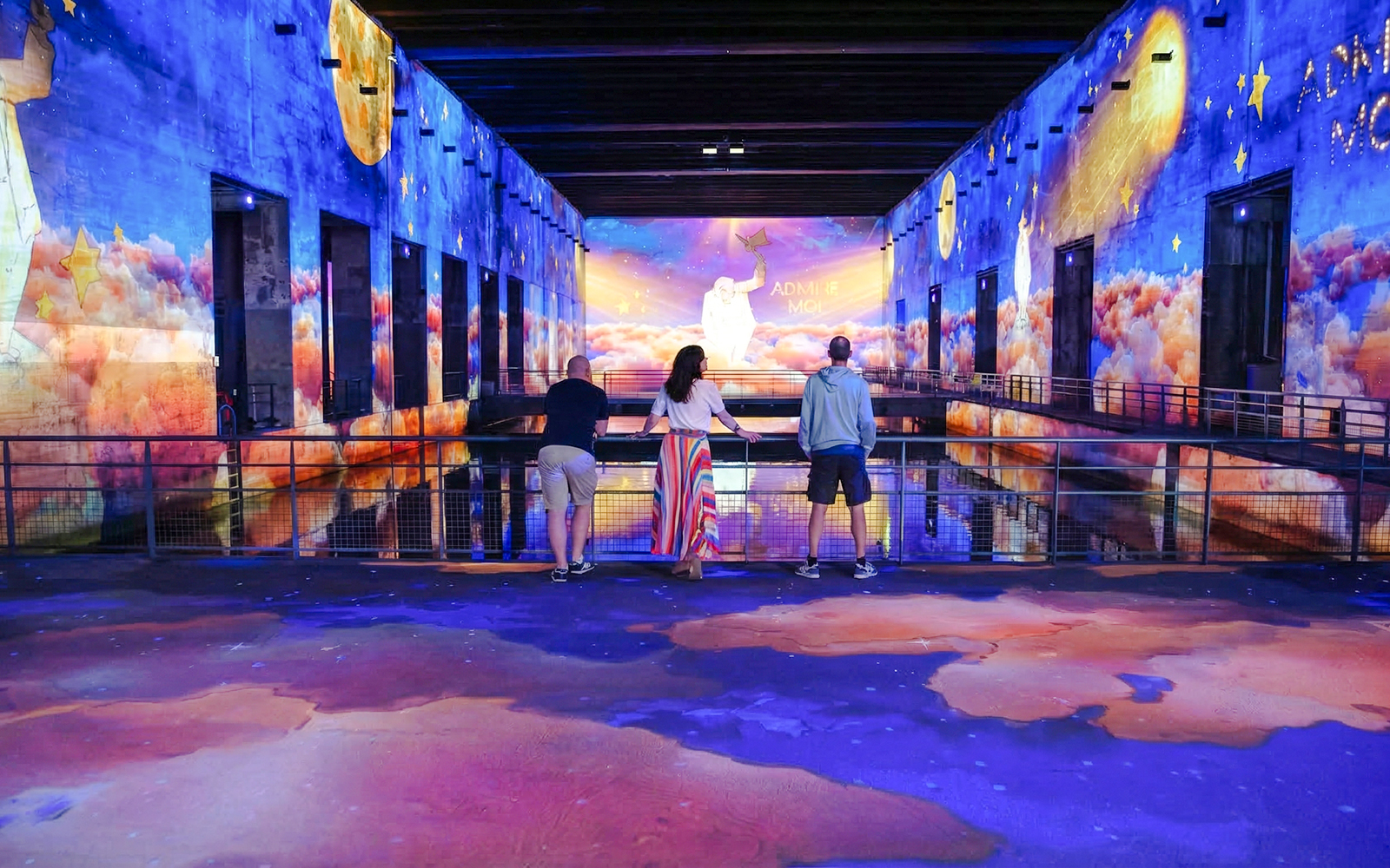 Visitors viewing "The Little Prince" immersive display at Bassins des Lumières, Bordeaux.